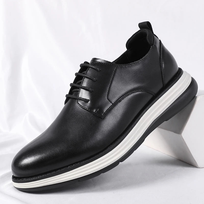 Black leather lace-up dress shoes with rubber sole on white background