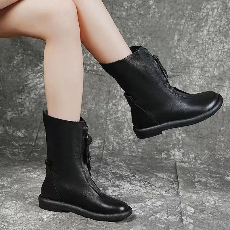 Side view of brown leather mid-calf boots featuring sleek zipper closure