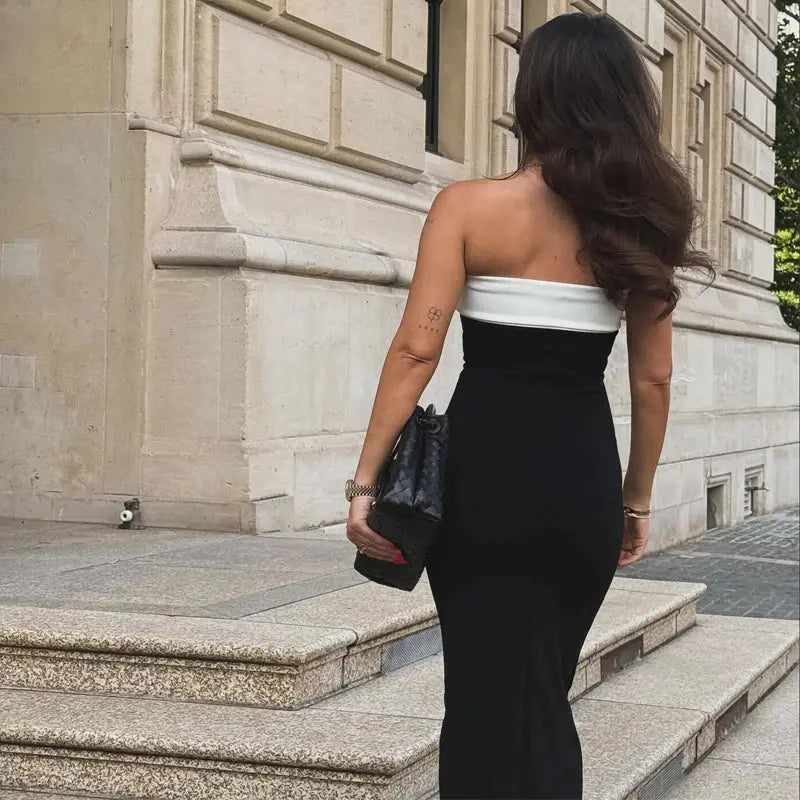Back view of the Midnight Allure Backless Midi Dress showcasing the delicate button accents along the spine.