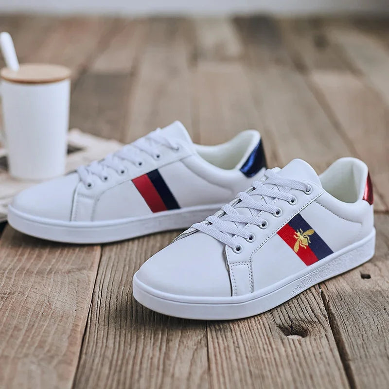 Street-style flat sneakers showcasing gold bee embroidery on premium microfiber