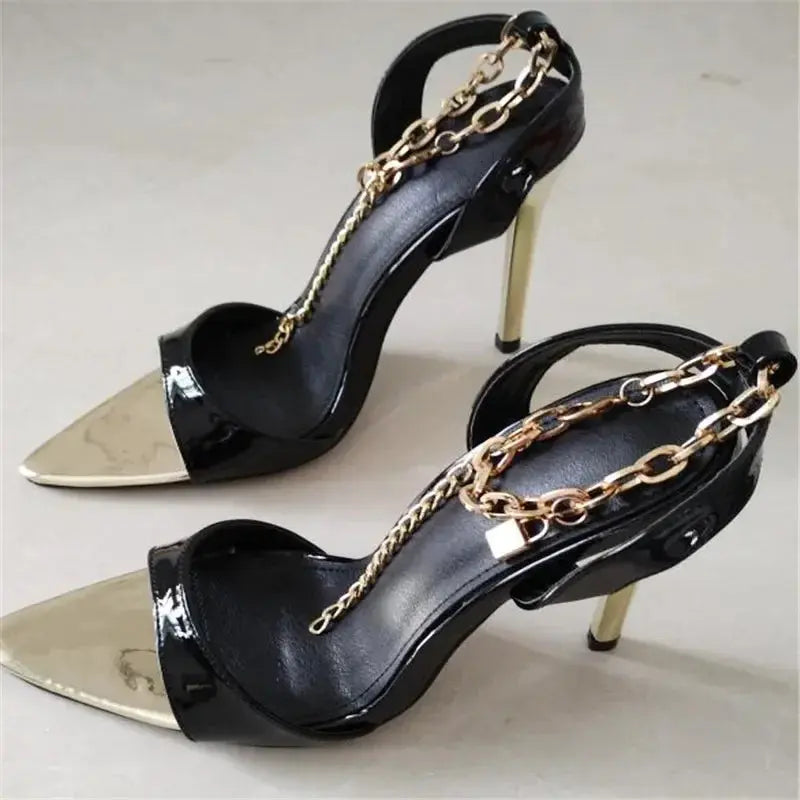 Close-up of black heels with dazzling metal decorations reflecting light beautifully.