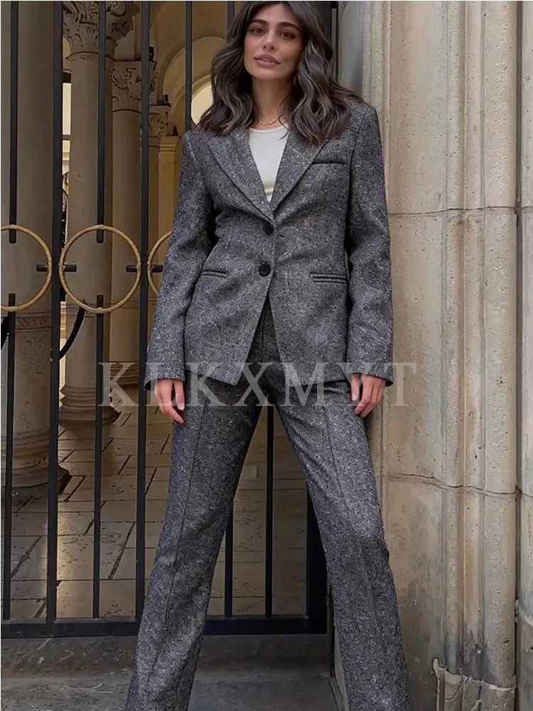 Chic black suit set with notched collar, tailored for modern women.