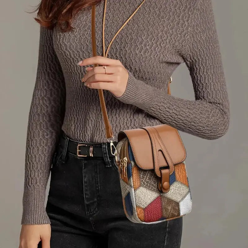 Rectangular crossbody bag featuring sparkly plaid design with dedicated phone storage compartment