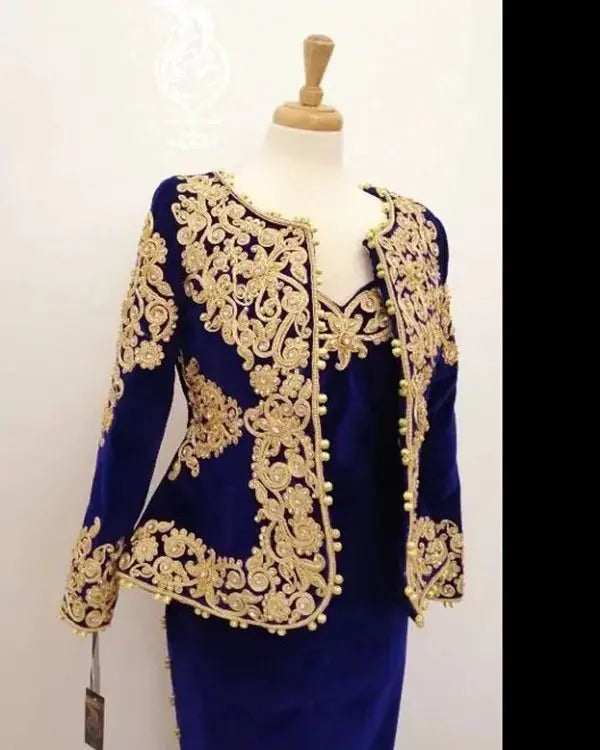 Long-sleeve jacket paired with a royal blue velvet gown, offering sophistication and warmth.