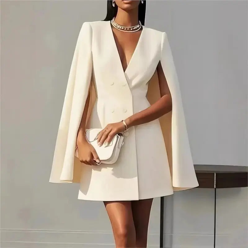 Flat lay of the black cloak blazer with tags highlighting easy care and breathable fabric.
