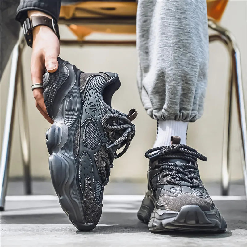 Side profile of men's casual athletic sneakers featuring mesh construction and durable sole