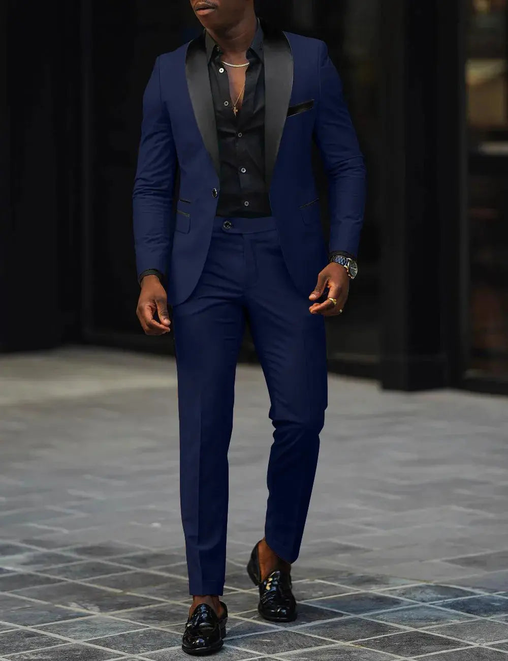 Model adjusting the lapel of the suit, showcasing its refined design.