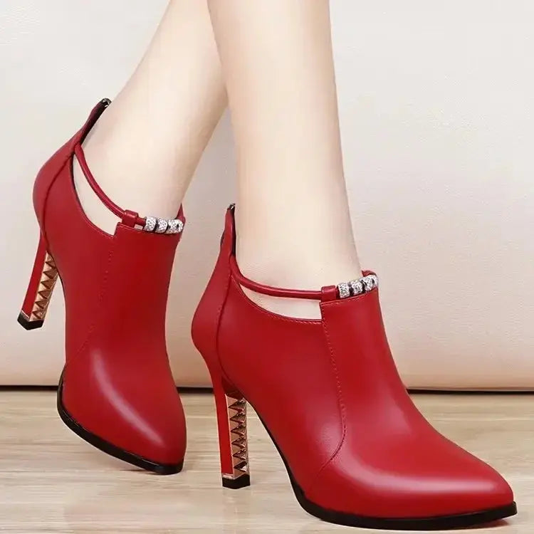 Red ankle boots styled with an evening outfit, making a bold statement.