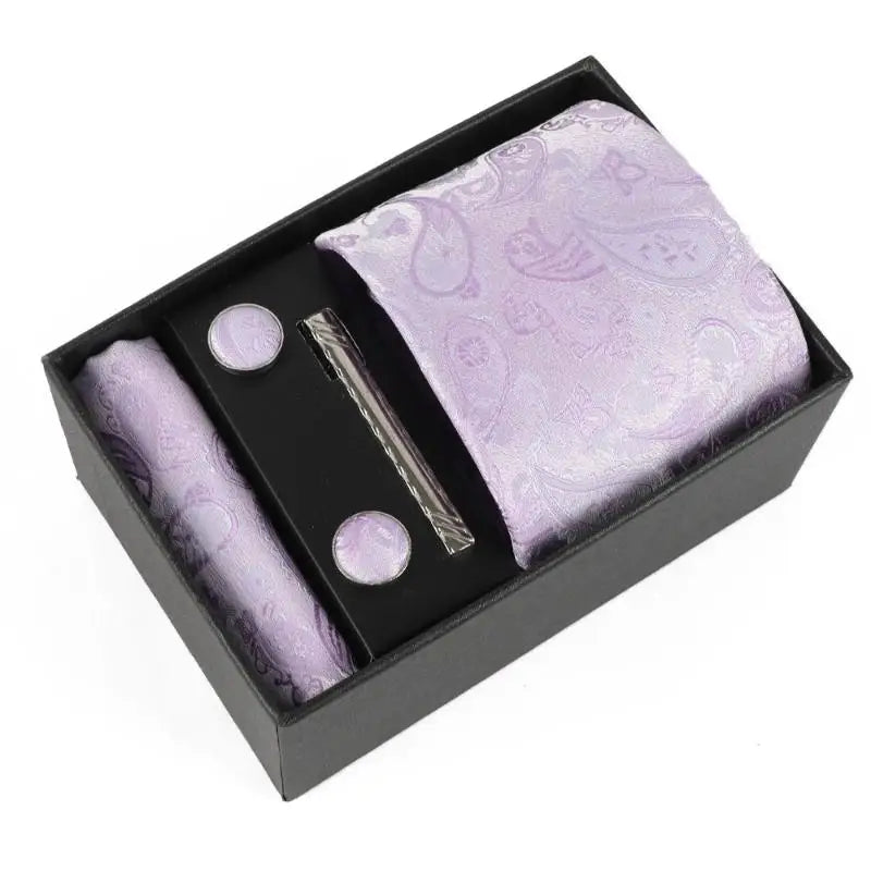 Complete ensemble of silk tie, pocket square, cufflinks, and clip.