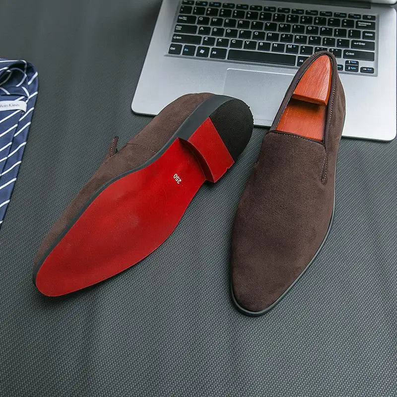 Premium suede loafers with iconic red sole and pointed toe shown from side angle