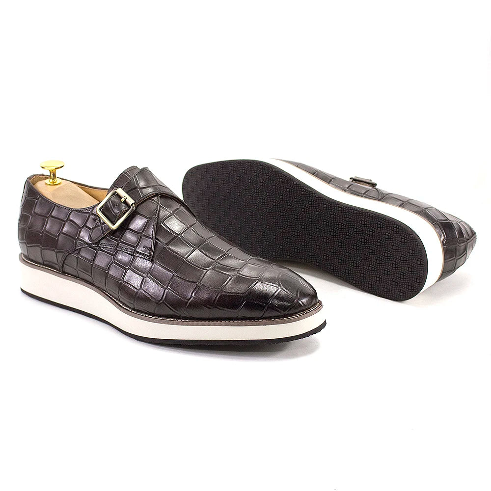 Side view of handcrafted leather monk strap shoes showing crocodile texture and height-increasing sole