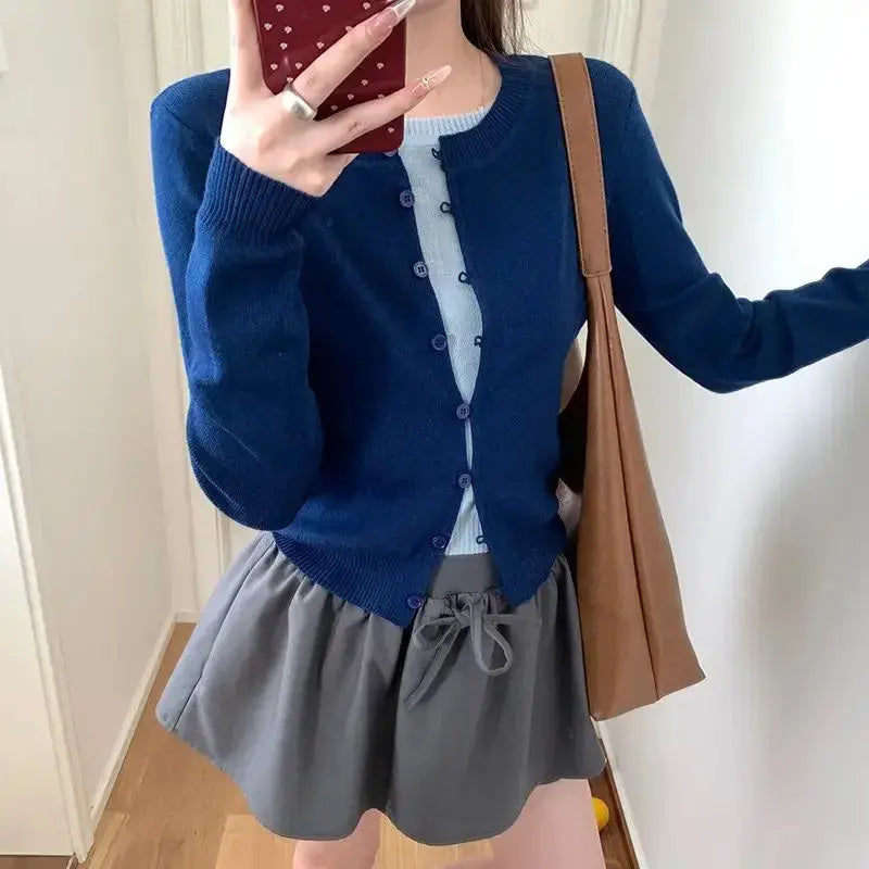 Model enjoying a cozy evening in the Whisper-Soft Cardigan, demonstrating its skin-friendly material.