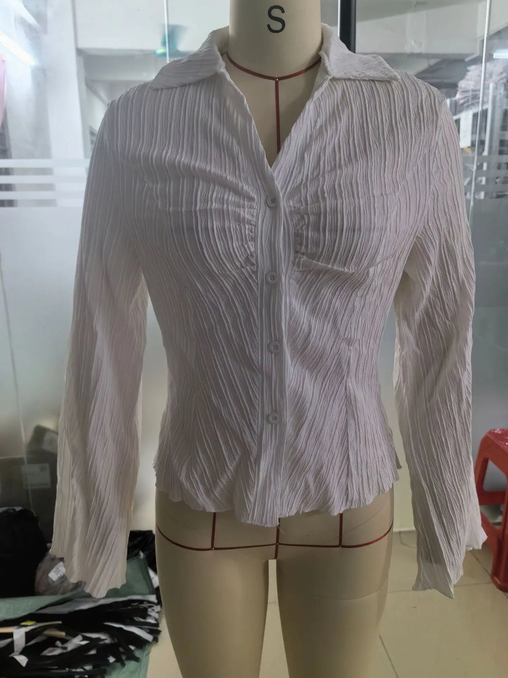 Premium polyester peplum blouse featuring ribbed texture and figure-enhancing fit