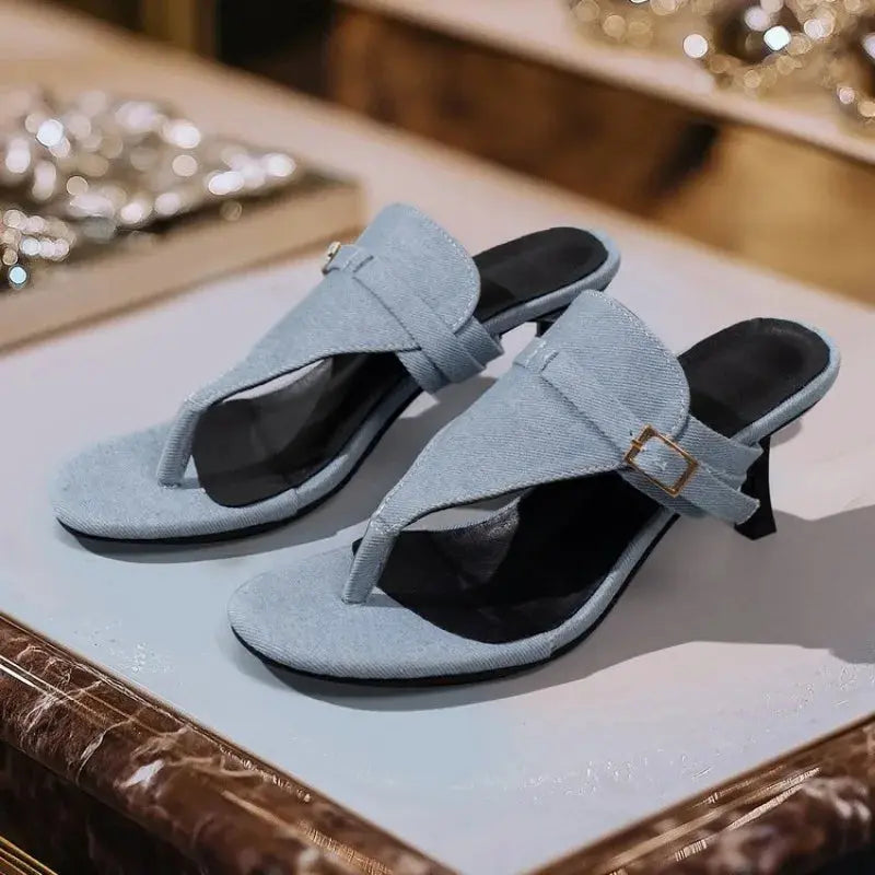 Chic black mules with thin heels that enhance posture while providing effortless grace.