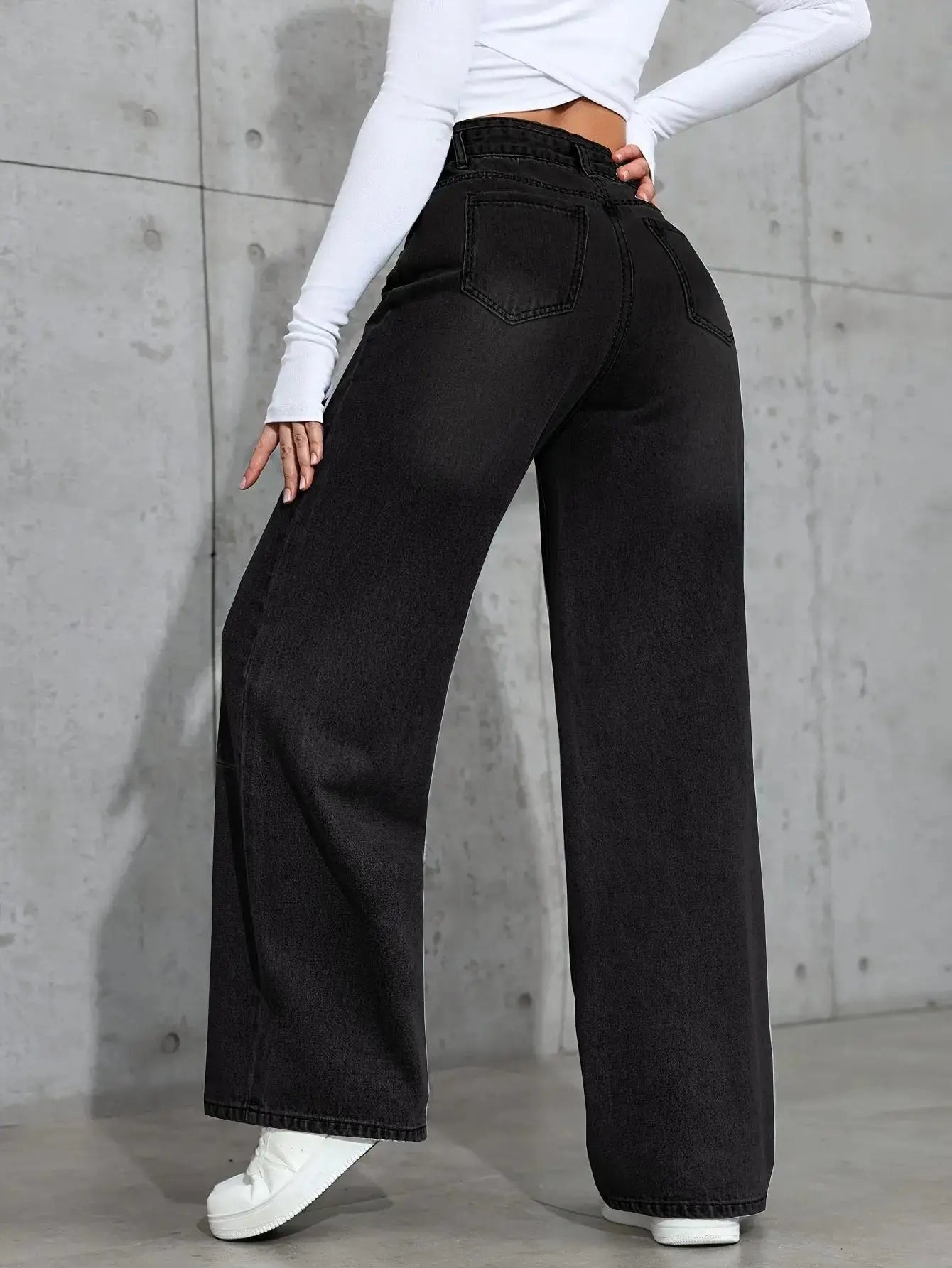 Close-up of high-waist jeans showcasing the smooth, clean design with no unnecessary adornments.