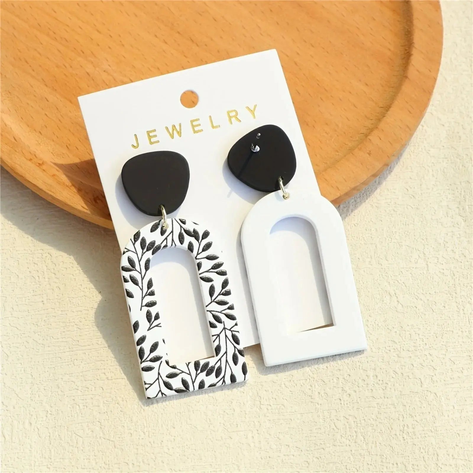 Elegant Whispering Leaves Drop Earrings dangling gracefully, inspired by nature's delicate beauty.