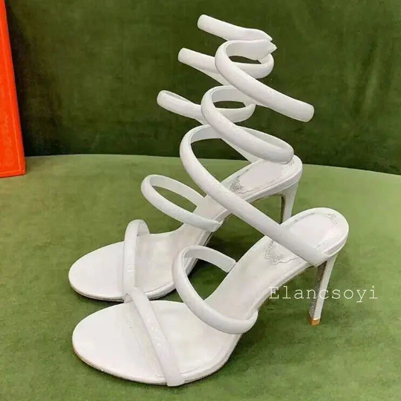 Elegant black heels displayed on a marble surface, highlighting luxury.