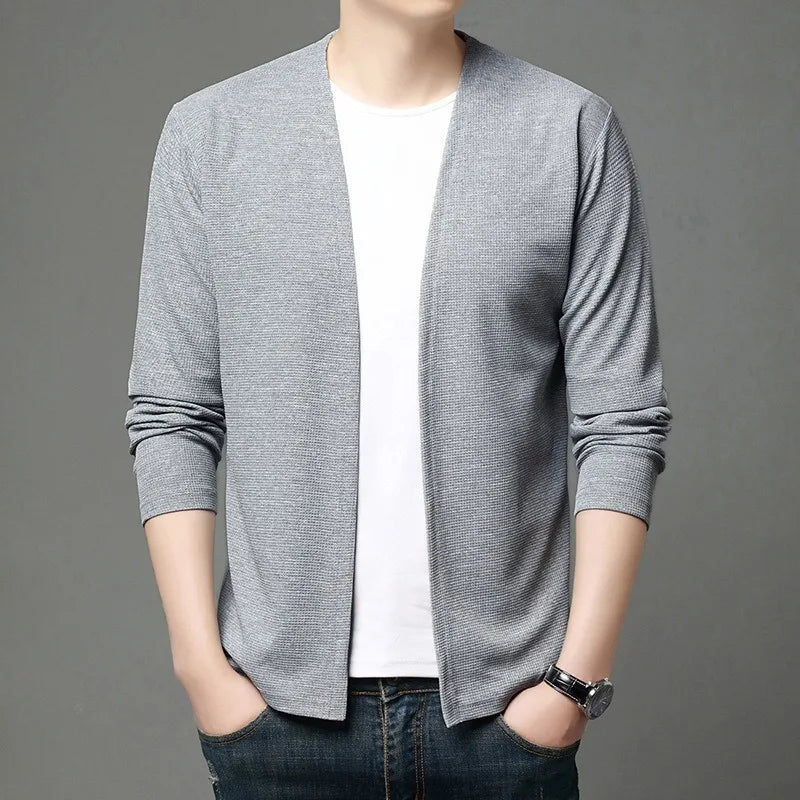 Model layering the cardigan over a shirt, perfect for autumn winter fashion.