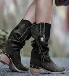 Mid-calf boots showcasing rich faux suede texture and bohemian tassel accents