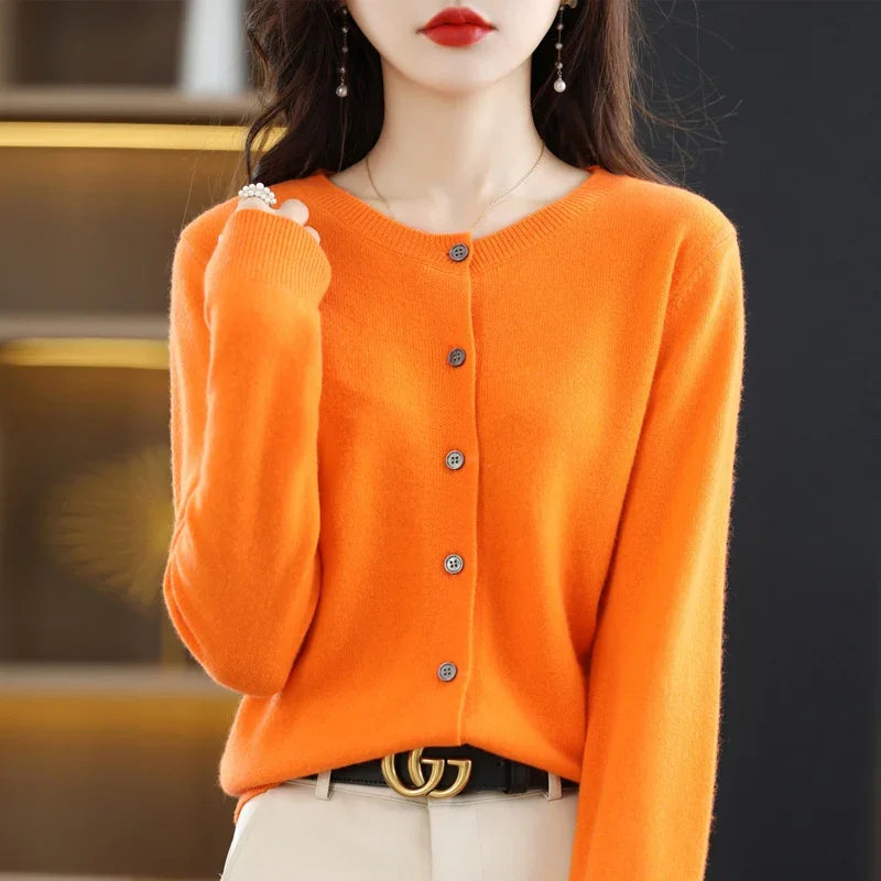 Flat lay of the Autumn Whisper Cardigan with autumn leaves, perfect for seasonal styling.