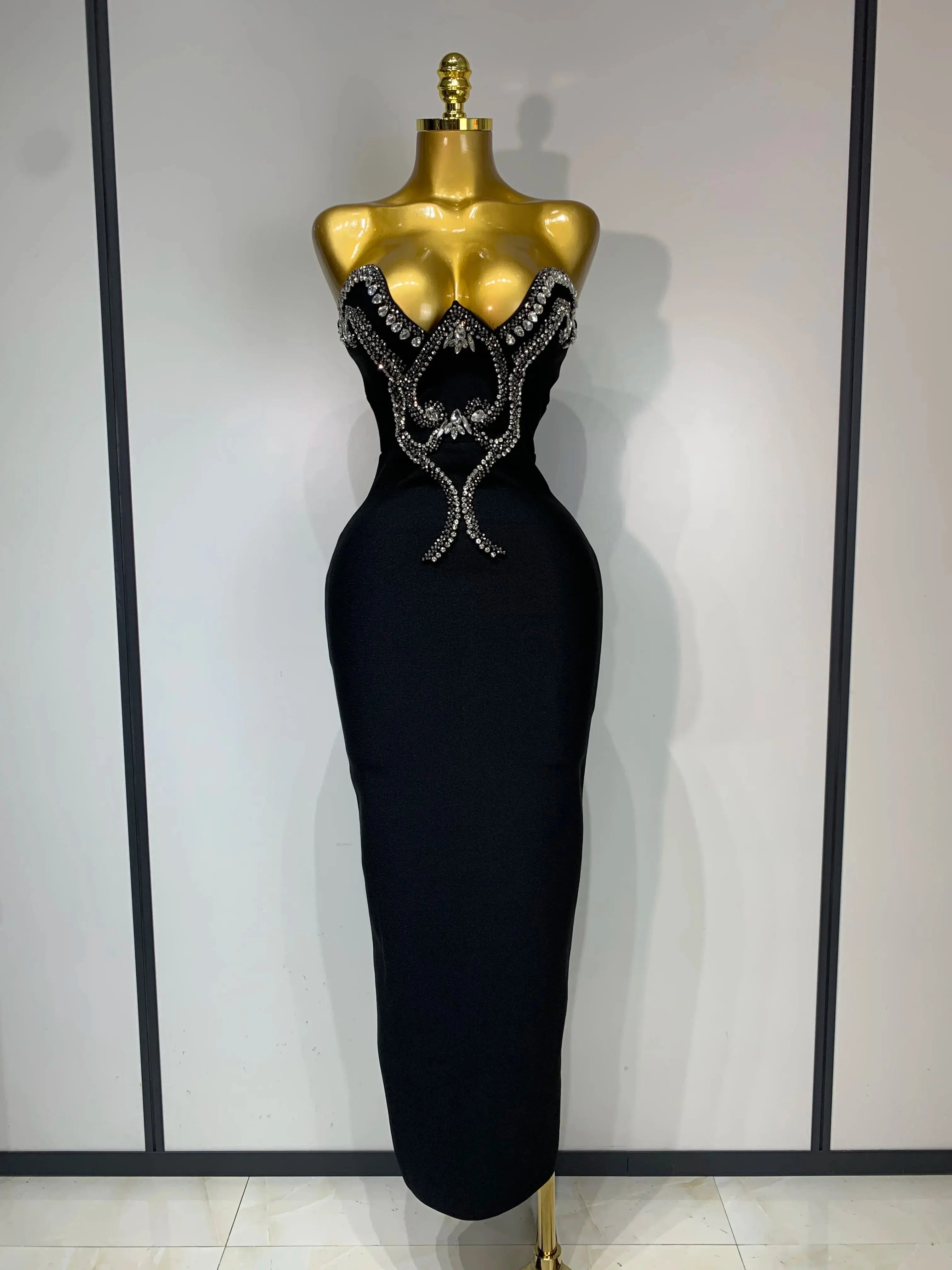 Strapless diamond gown in shimmering fabric, showcasing intricate beaded detailing.