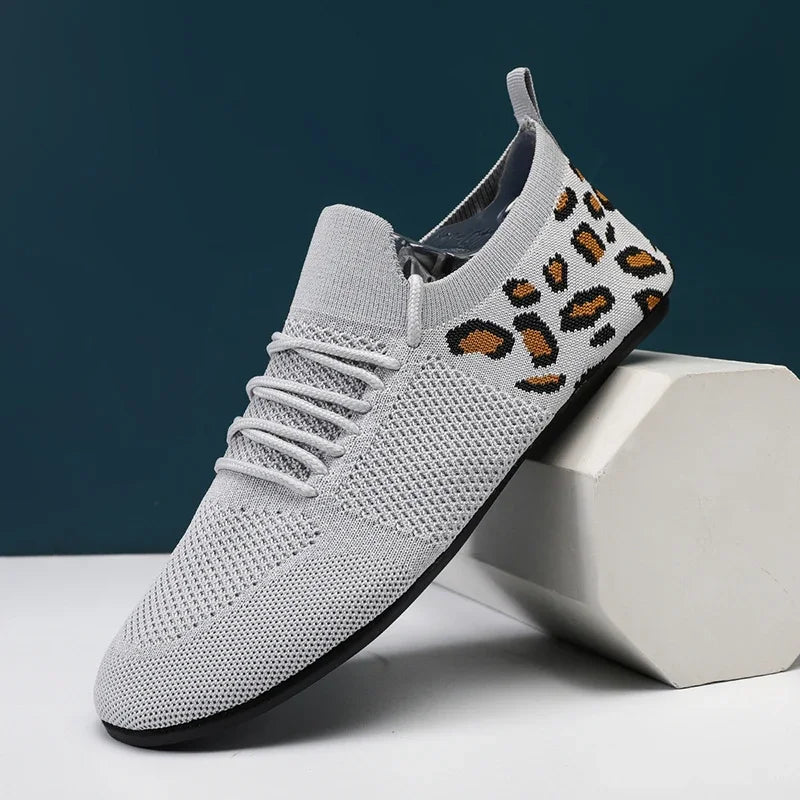 Side view of black dynamic mesh sneakers, perfect for stylish city walks and effortless movement.