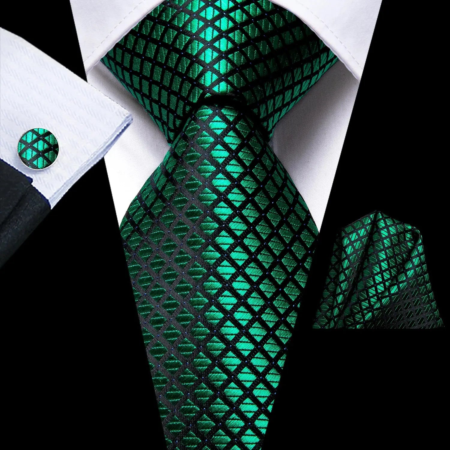 Silk tie set featuring rich paisley design on deep green plaid background.
