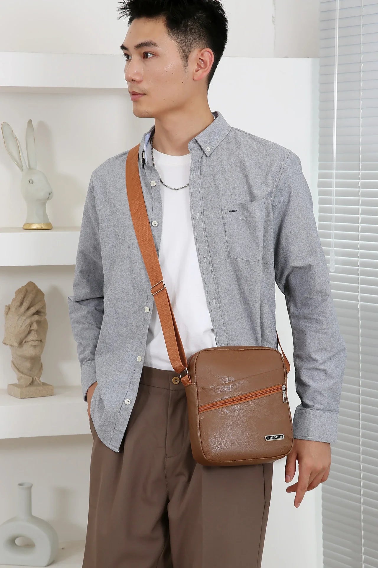 Black crossbody messenger bag protecting belongings from unexpected rain and urban elements