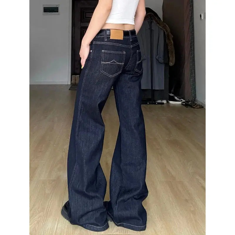 High-waisted wide-leg jeans in vintage wash, embodying Y2K streetwear style.