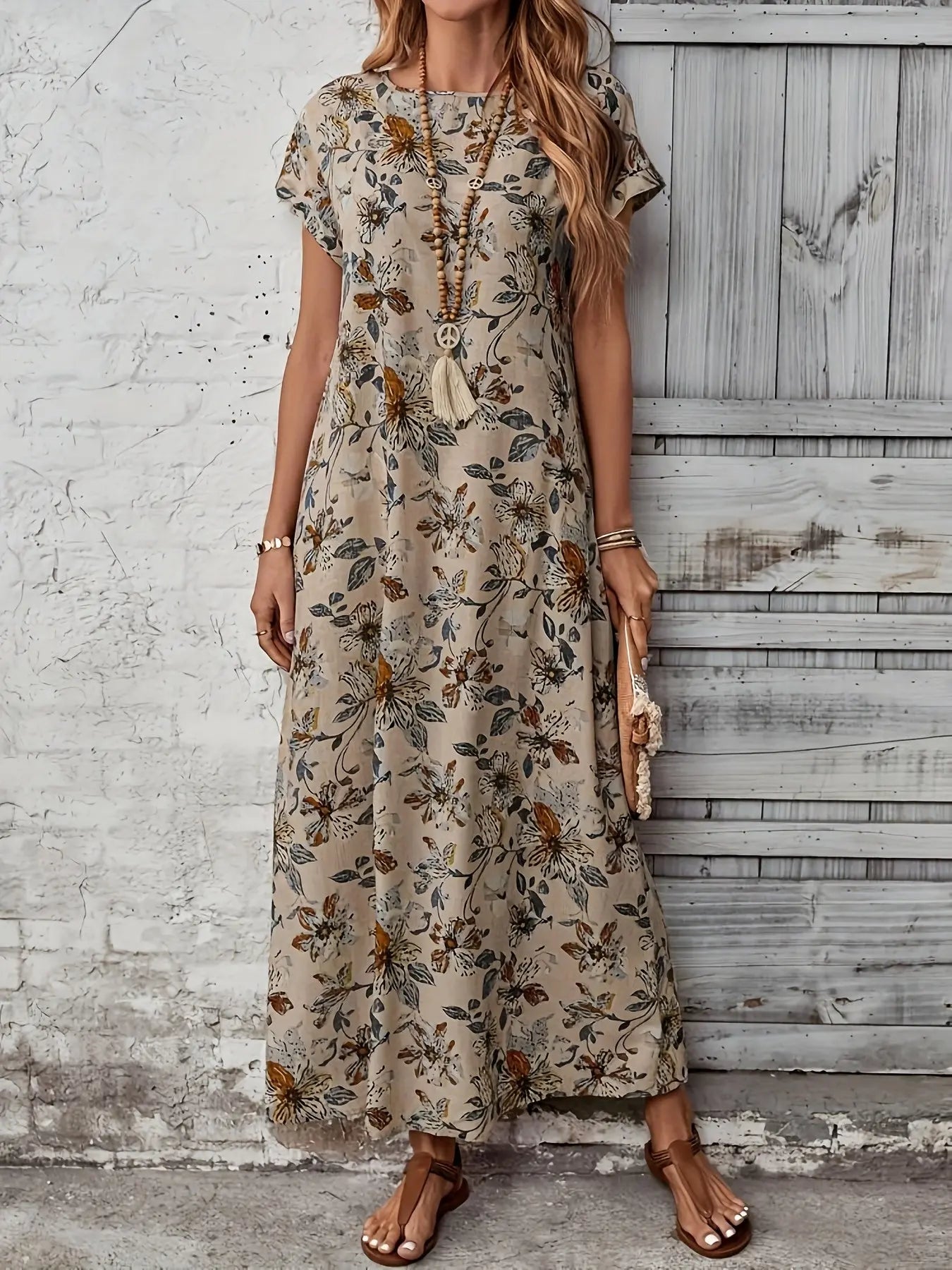 Woman enjoying a seaside stroll in the Whisper-Soft Floral Dress, embodying effortless summer style.