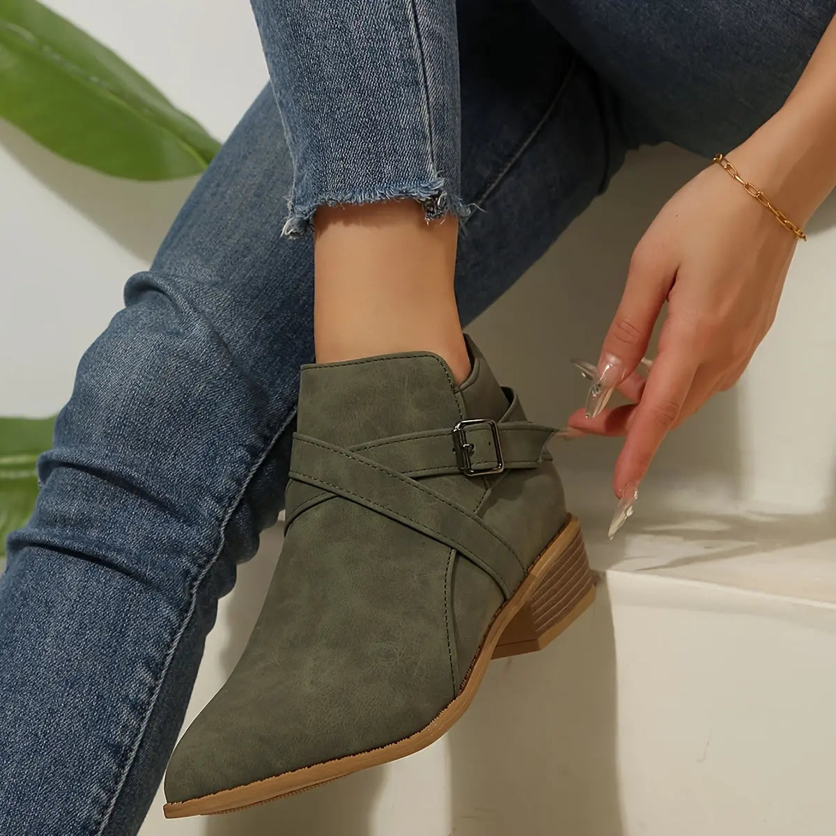 Elegant olive block heel boots paired with a dress for versatile wear.