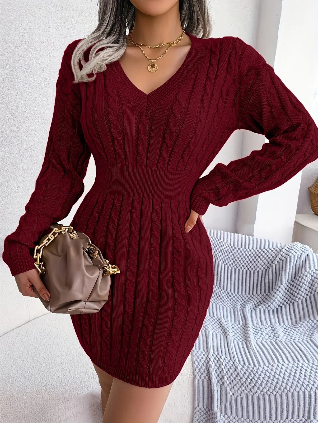 Versatile burgundy sweater dress styled with heels for a chic look or boots for casual wear.