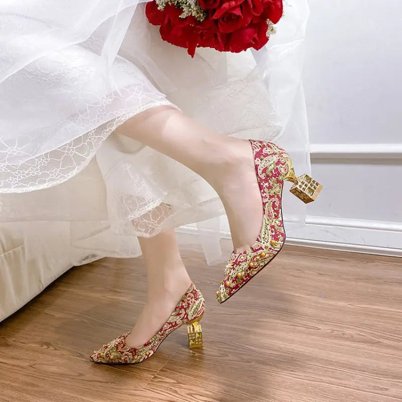 Close-up of delicate embroidery on traditional Chinese bridal shoes.