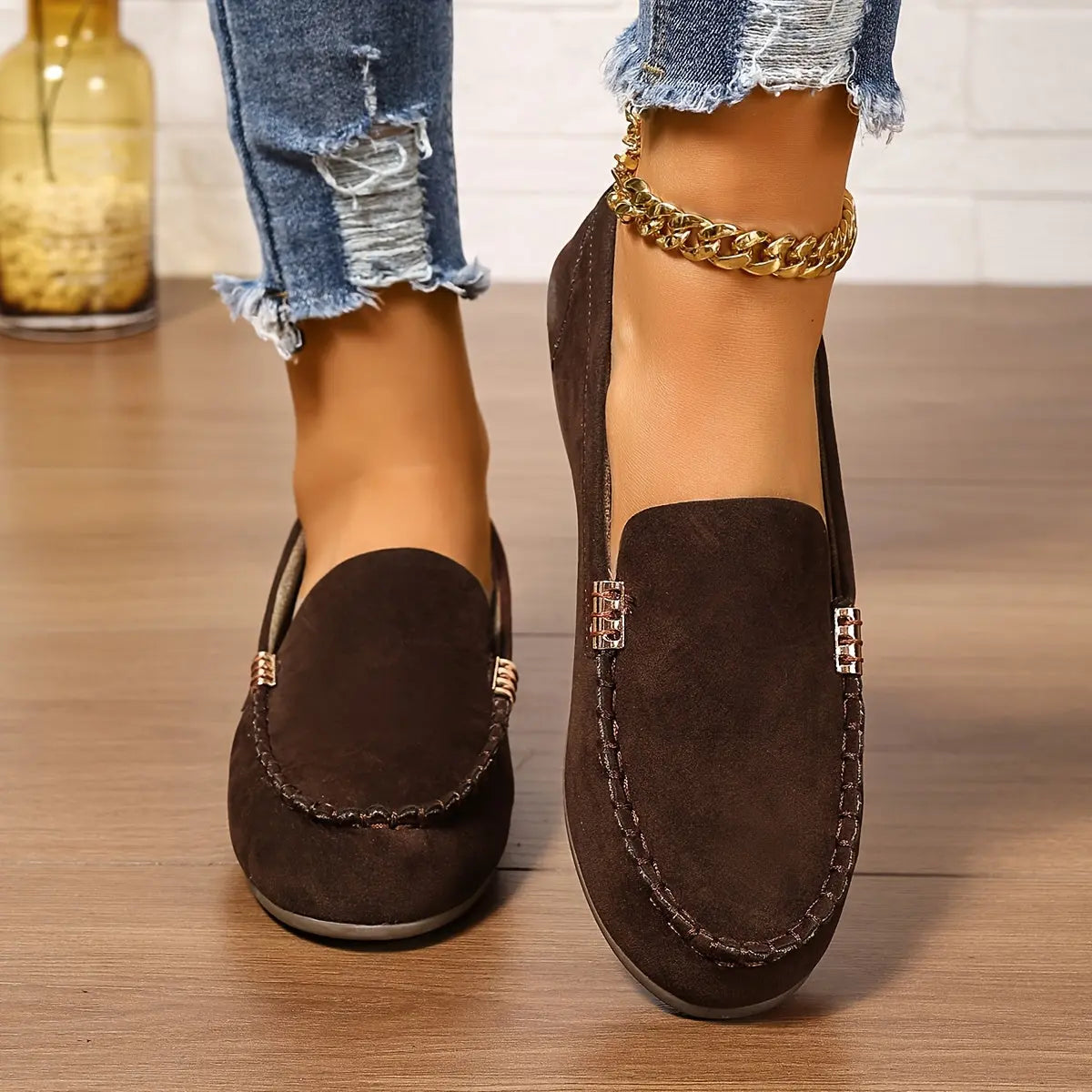 Loafers displayed on a wooden surface, emphasizing their versatile aesthetic.