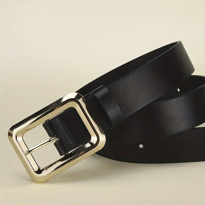 Close-up of the shimmering zinc alloy golden buckle on a stylish belt.