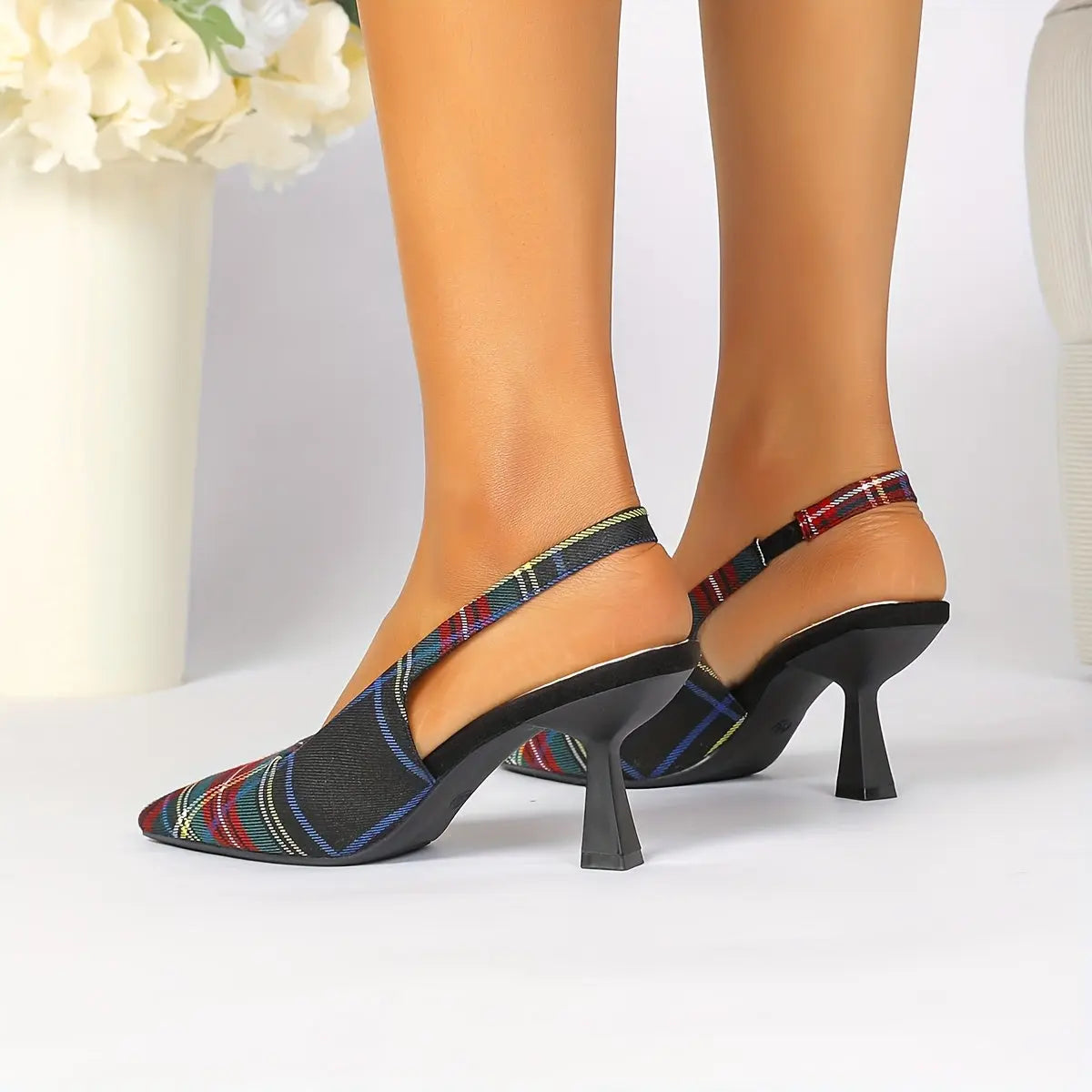 Model wearing plaid pointed-toe mules paired with a casual outfit.