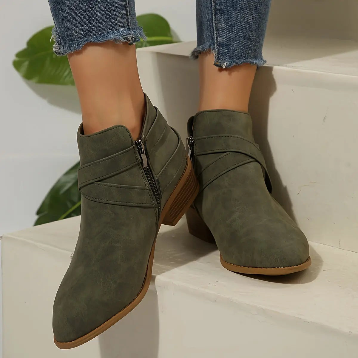 Top view of pointed toe design on olive block heel boots.