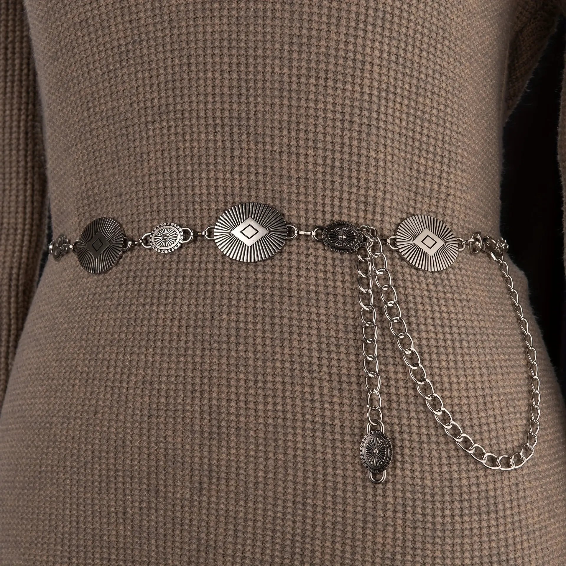 Detailed view of the soft metallic sheen of the Golden Hour Glow waist chain.